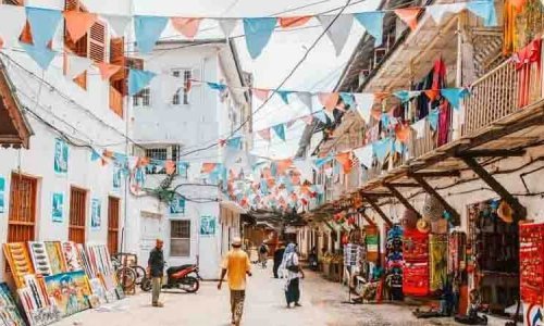 Local people on a street in Stone Town. Stone Town is the old part of Zanzibar City, the capital of Zanzibar